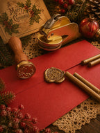 Gold wax seal being pressed into the red envelope of a Santa Ink letter